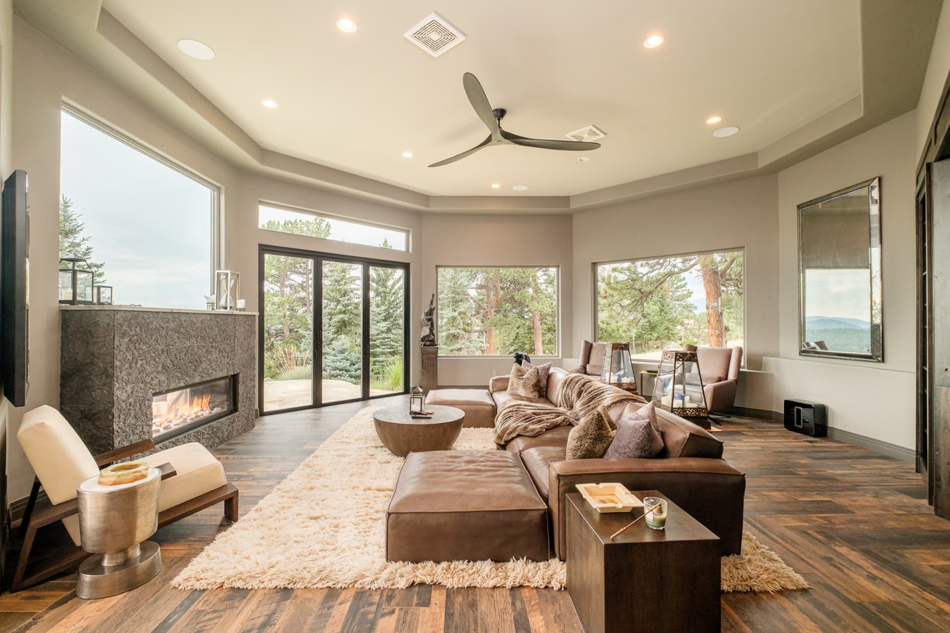 Family room with stone fireplace and panoramic windows