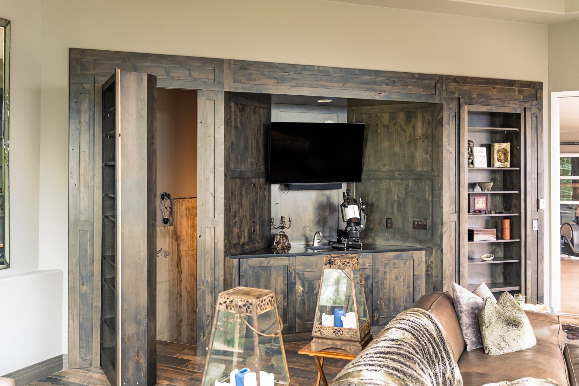 Built-in walnut shelving with concealed door