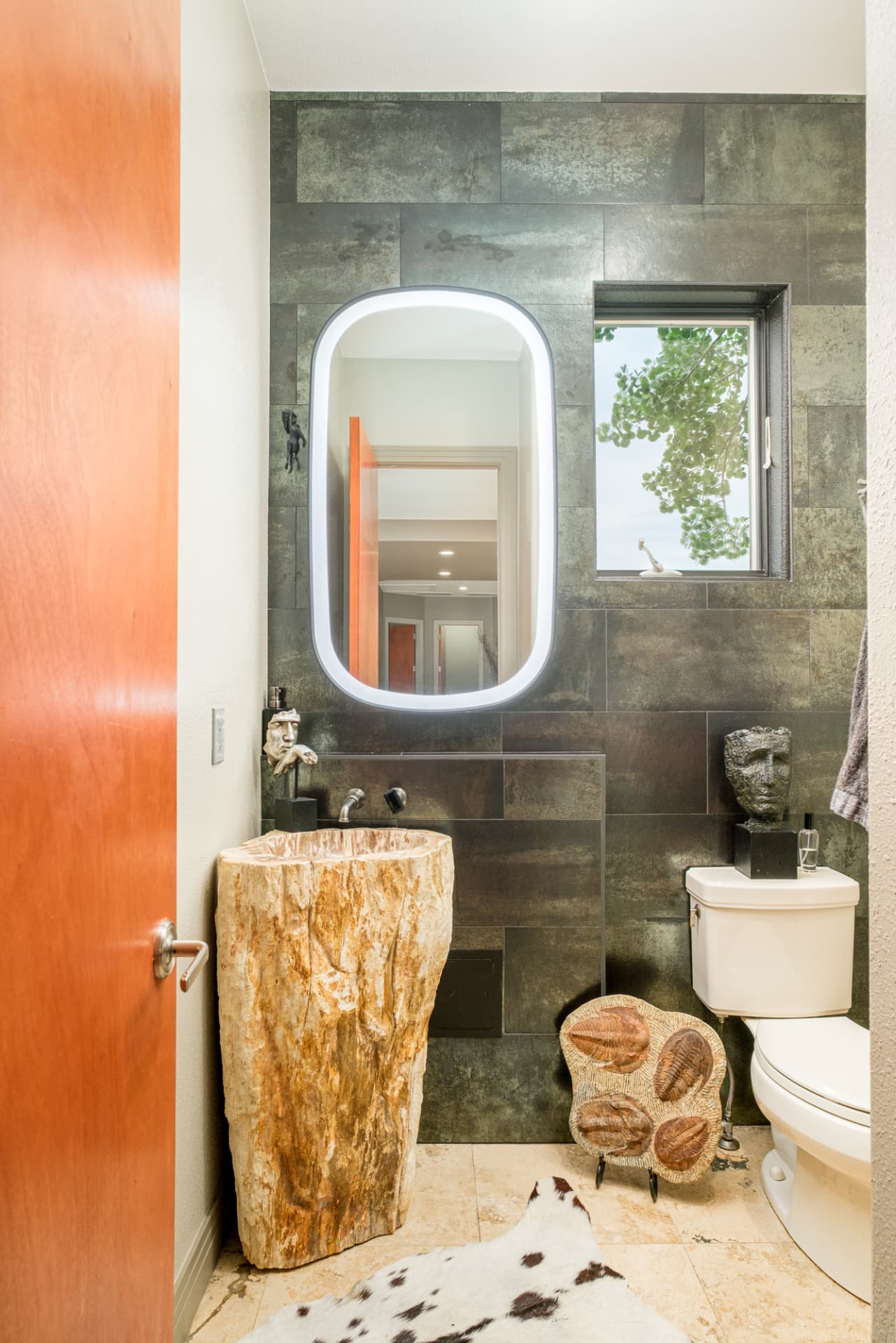 Powder room with petrified wood pedestal sink