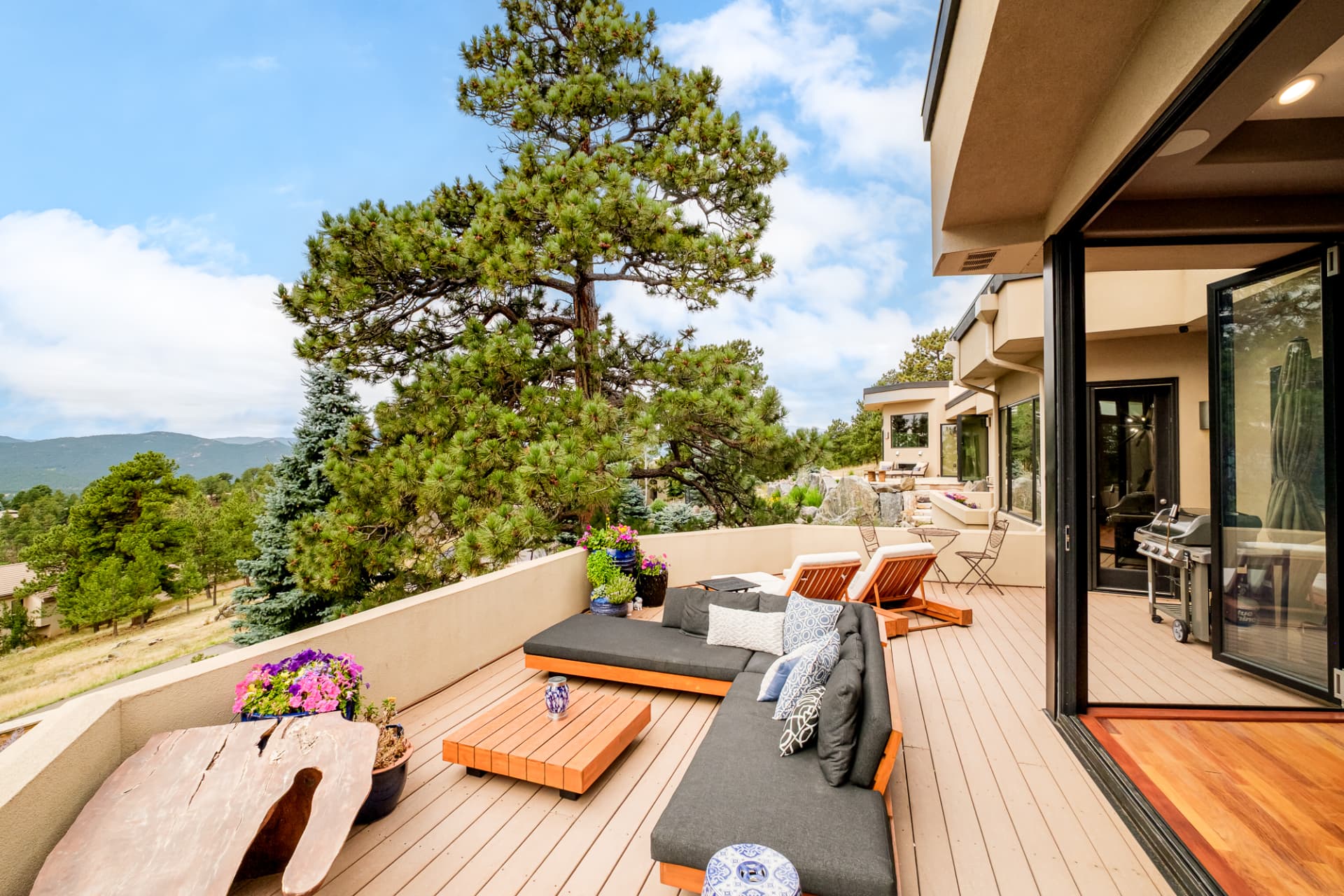 Deck with live-edge table and outdoor sofa