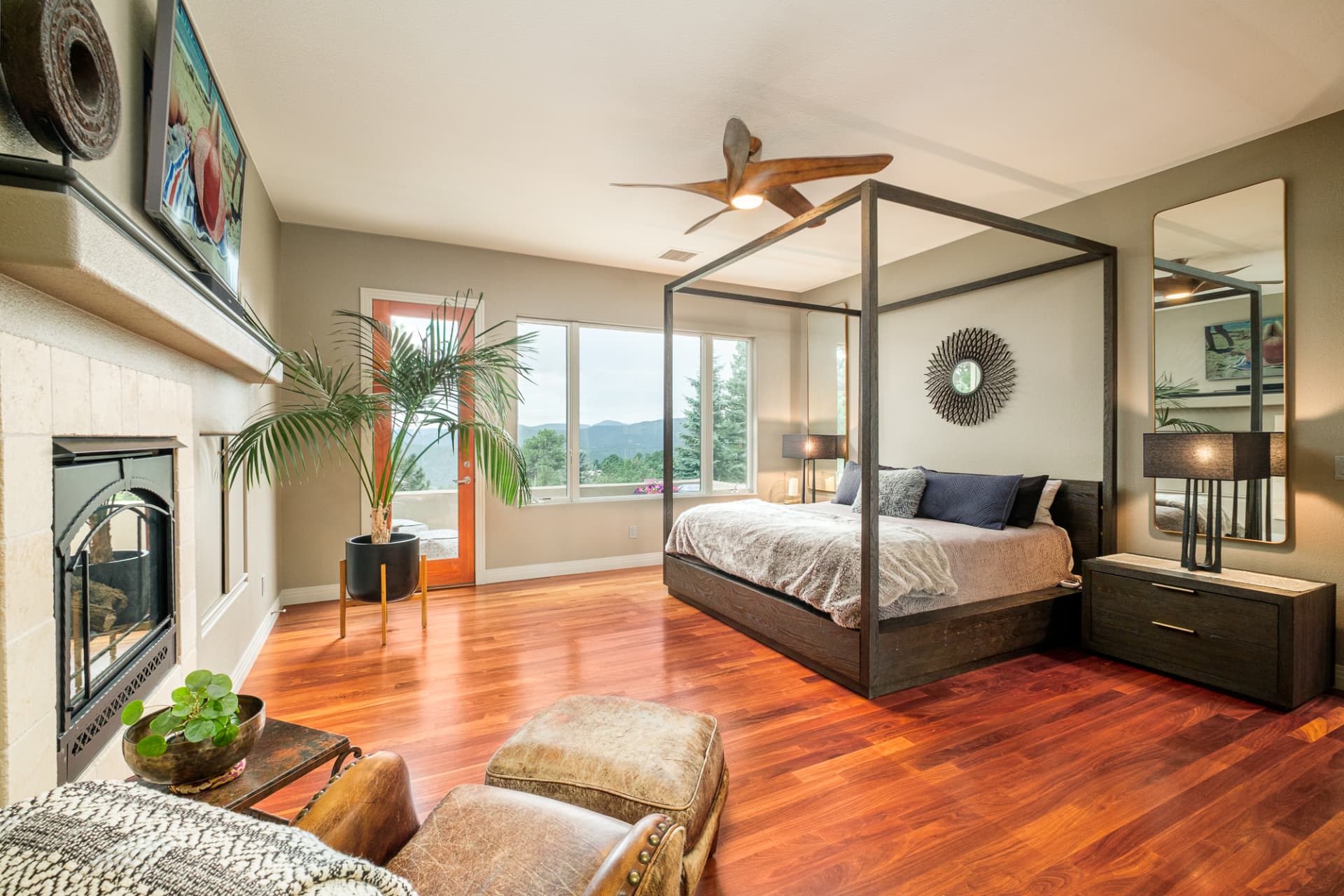 Primary bedroom with canopy bed and fireplace