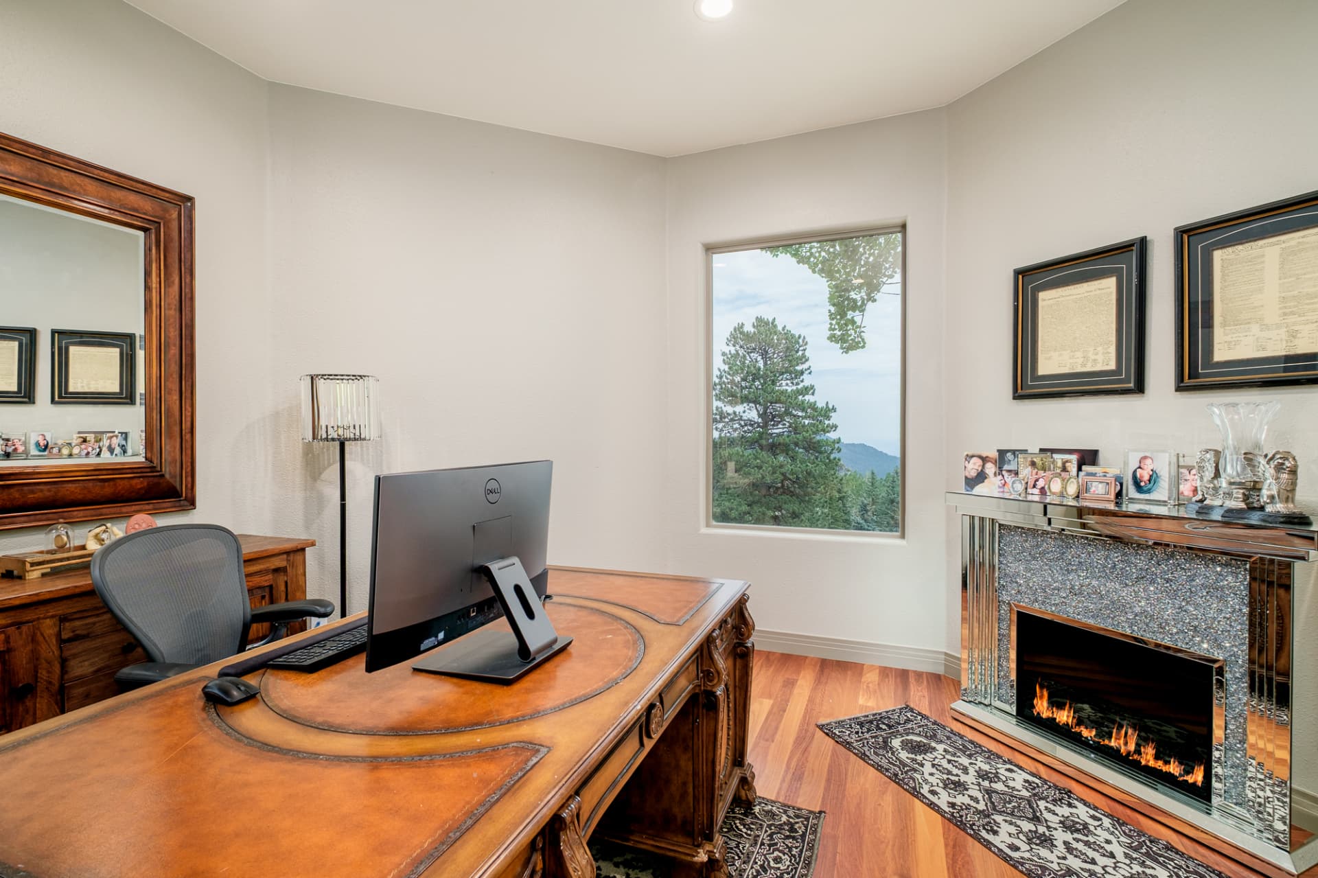 Home office with leather-topped desk and fireplace