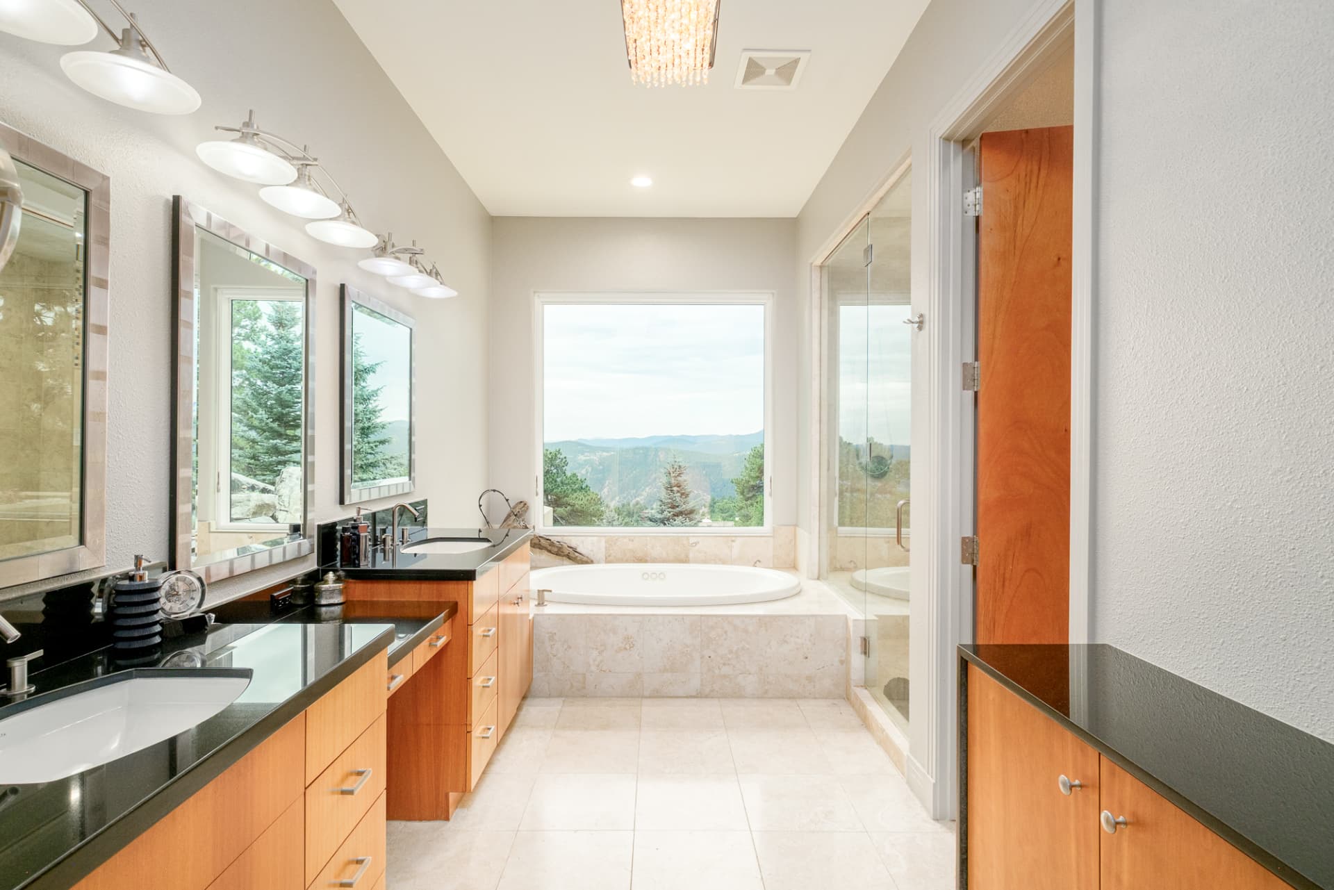 Primary bath soaking tub set beneath a mountain-view window