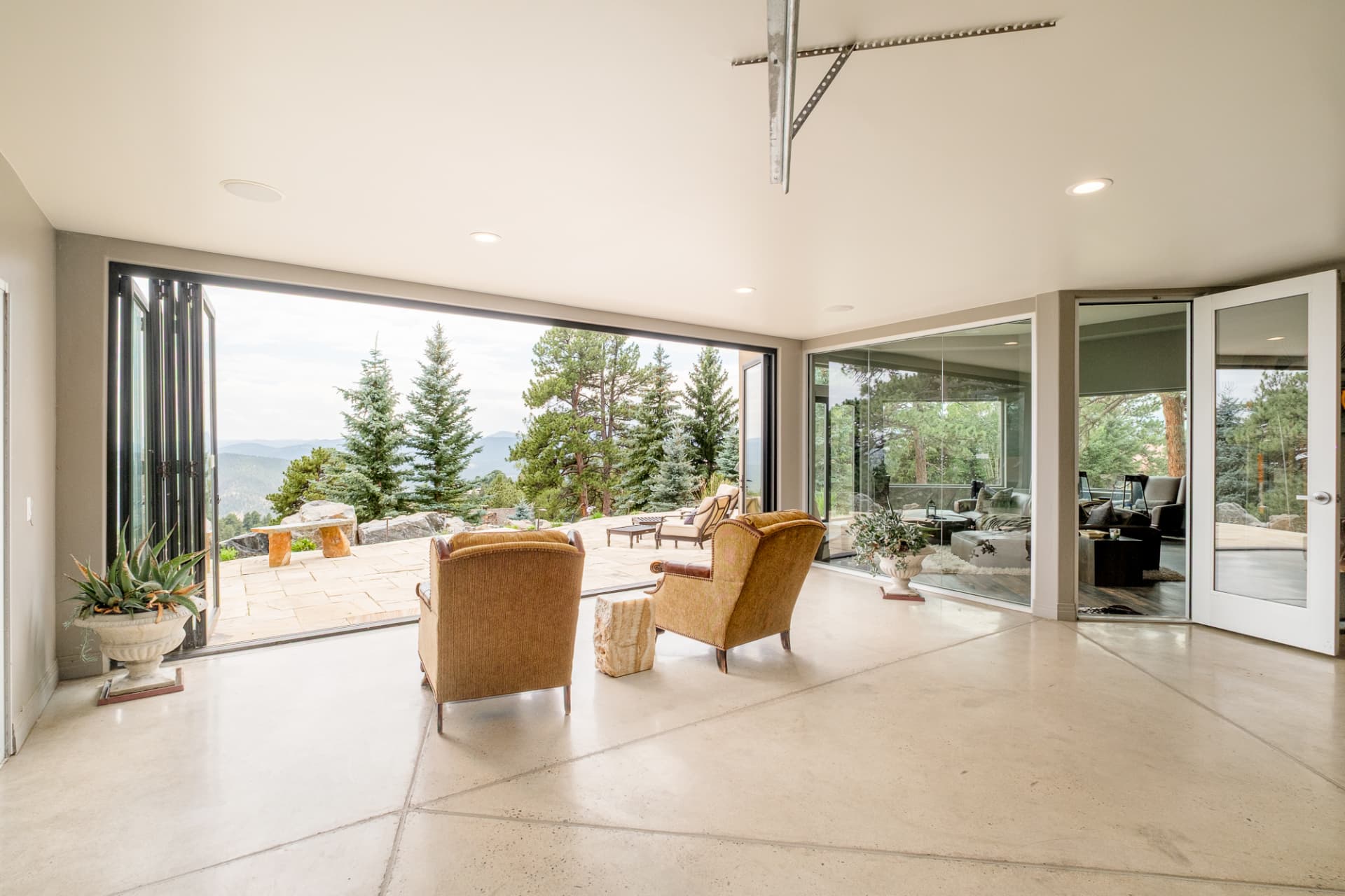 Sunroom with folding glass walls open to the patio